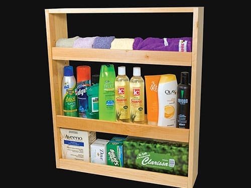 A bathroom slide out drawer with body washes and shampoos