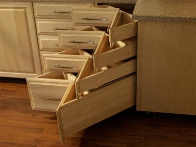 An image of a kitchen with 3 small and 1 large corner drawers