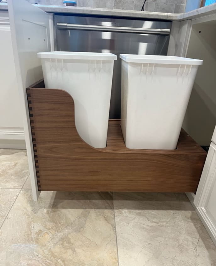 A side view of A Dual Trash drawer in a kitchen with two trash bins